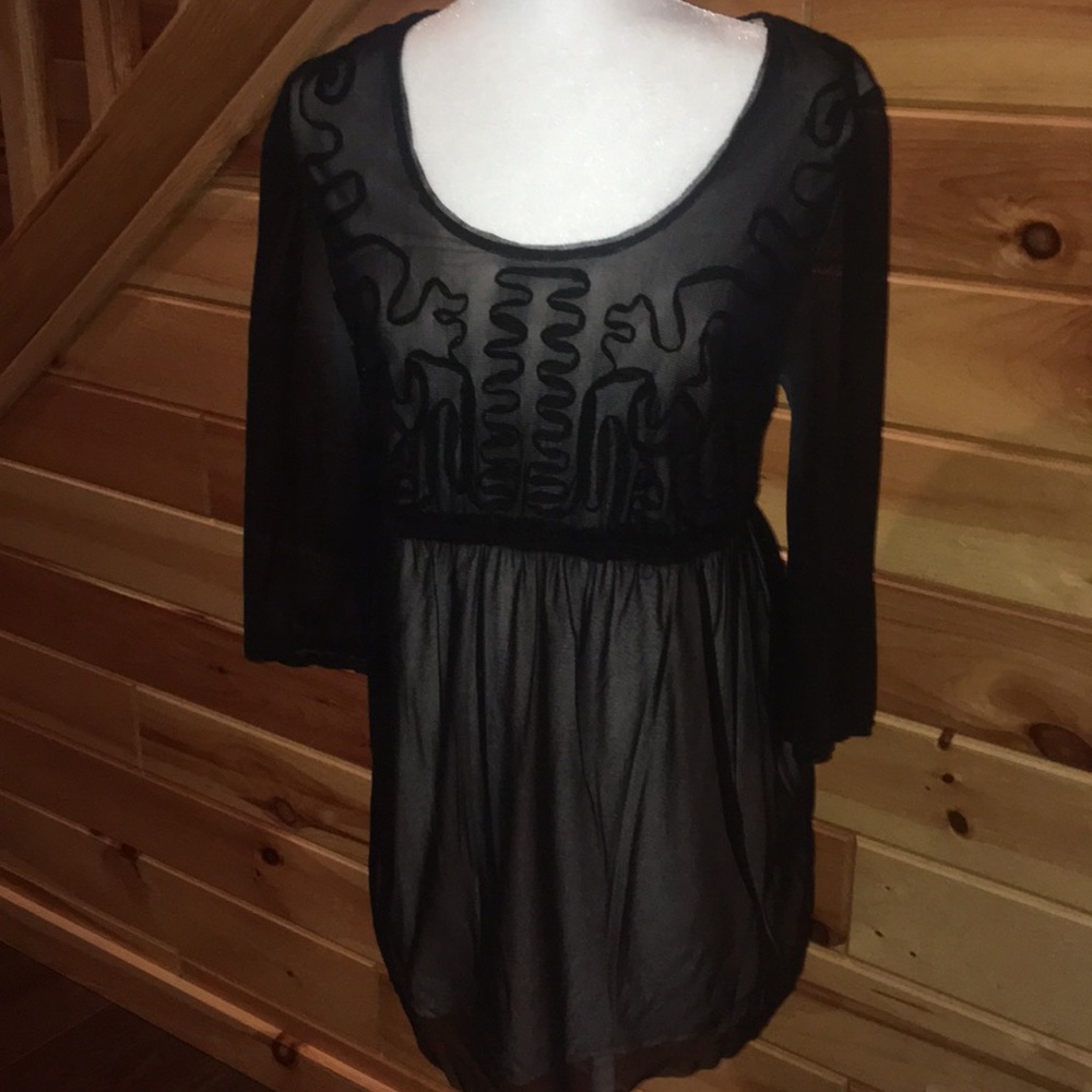 Sheer black 3/4 sleeve top over pale pink cotton